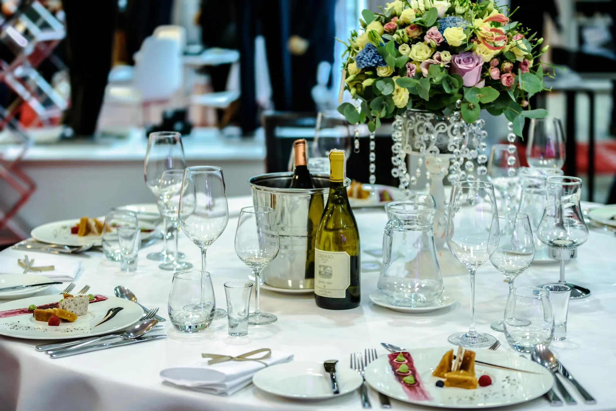 A beautiful, table setting with food and wine in a fine-dining restaurant.