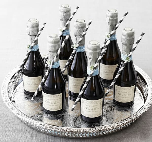 Miniature bottles of wine arranged as elegant guest favours