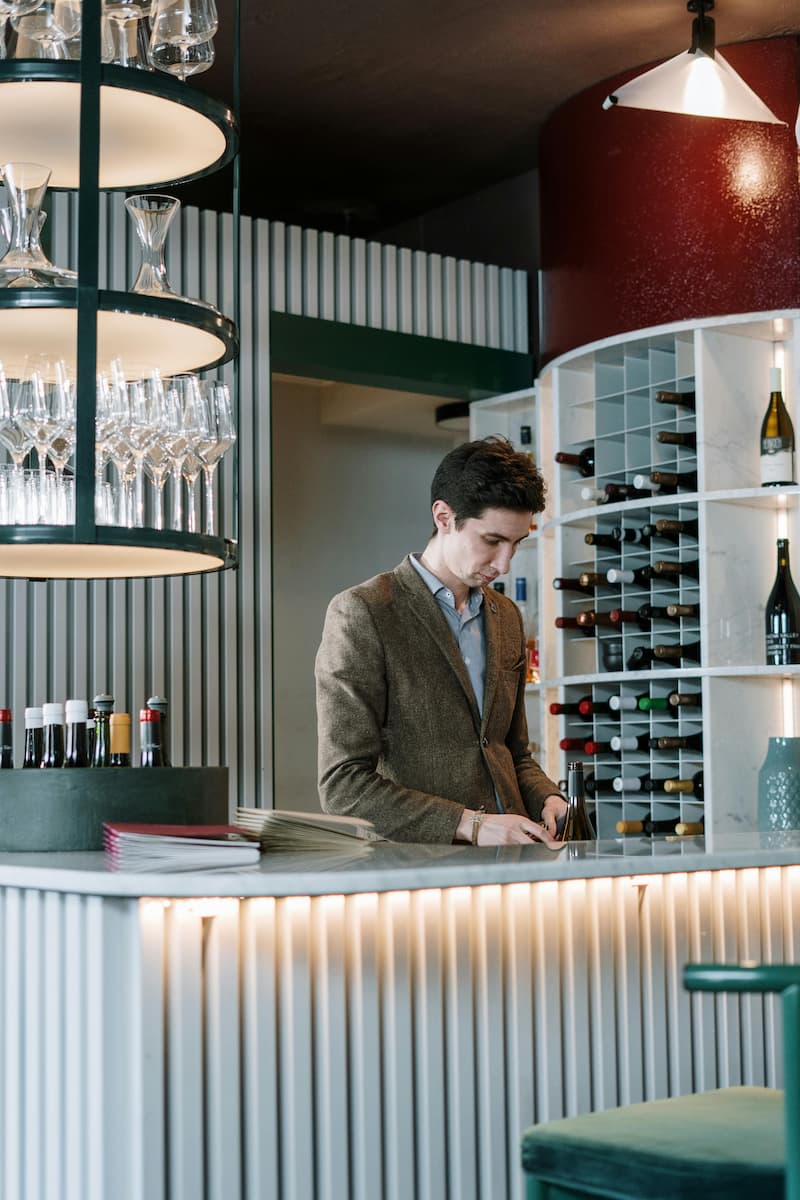 A sommelier strategically reviewing a wine list in a restaurant